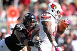CINCINNATI, OH - OCTOBER 15: Derek Wolfe #95 of the Cincinnati Bearcats tackles Dominique Brown #10 of the Louisville Cardinals during the game at Paul Brown Stadium on October 15, 2011 in Cincinnati, Ohio.  (Photo by Andy Lyons/Getty Images)