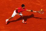 PARIS, FRANCE - MAY 31:  Rafael Nadal of Spain stretches for a backhand during his men's singles second round match against Denis Istomin of Uzbekistan during day five of the French Open at Roland Garros on May 31, 2012 in Paris, France.  (Photo by Clive Brunskill/Getty Images)