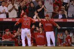 ANAHEIM, CA - MAY 29:  Mark Trumbo #44 of the Los Angeles Angels celebrates his homerun with Mike Scioscia, C.J. Wilson #33,Rob Picciolo #9 and Dan Haren #24 for a 4-1 lead over the New York Yankees during the sixth inning at Angel Stadium of Anaheim on May 29, 2012 in Anaheim, California.  (Photo by Harry How/Getty Images)