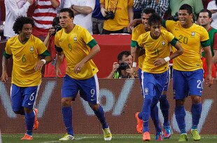 LANDOVER, MD - MAY 30: Neymar #11 of Brazil is congratulated by teammates after scoring a goal against USA during an International friendly game at FedExField on May 30, 2012 in Landover, Maryland.  (Photo by Rob Carr/Getty Images)