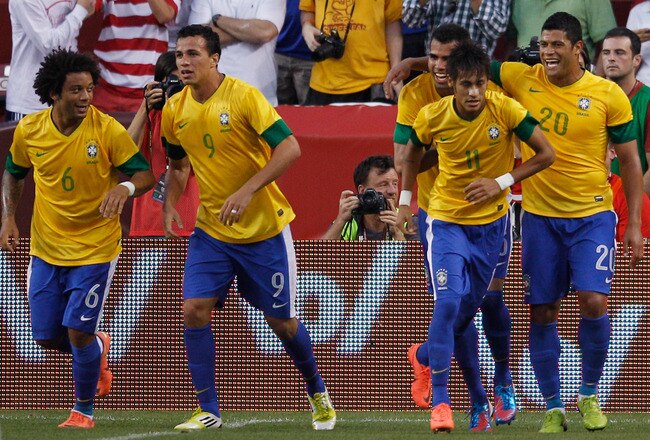 LANDOVER, MD - MAY 30: Neymar #11 of Brazil is congratulated by teammates after scoring a goal against USA during an International friendly game at FedExField on May 30, 2012 in Landover, Maryland.  (Photo by Rob Carr/Getty Images)
