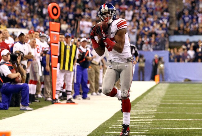 INDIANAPOLIS, IN - FEBRUARY 05:  Mario Manningham #82 of the New York Giants attempts to make a catch against the New England Patriots during Super Bowl XLVI at Lucas Oil Stadium on February 5, 2012 in Indianapolis, Indiana.  (Photo by Al Bello/Getty Images)