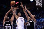 OKLAHOMA CITY, OK - MAY 31:  Kevin Durant #35 of the Oklahoma City Thunder goes up for a dunk between Boris Diaw #33 and Tim Duncan #21 of the San Antonio Spurs in the second quarter in Game Five of the Western Conference Finals of the 2012 NBA Playoffs at Chesapeake Energy Arena on May 31, 2012 in Oklahoma City, Oklahoma. NOTE TO USER: User expressly acknowledges and agrees that, by downloading and or using this photograph, User is consenting to the terms and conditions of the Getty Images License Agreement.  (Photo by Brett Deering/Getty Images)