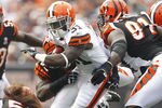 CLEVELAND, OH - SEPTEMBER 11:  Montario Hardesty #31 of the Cleveland Browns runs the ball by defensive end Robert Geathers #91 of the Cincinnati Bengals during the season opener at Cleveland Browns Stadium on September 11, 2011 in Cleveland, Ohio.  (Photo by Matt Sullivan/Getty Images)