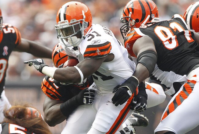 CLEVELAND, OH - SEPTEMBER 11:  Montario Hardesty #31 of the Cleveland Browns runs the ball by defensive end Robert Geathers #91 of the Cincinnati Bengals during the season opener at Cleveland Browns Stadium on September 11, 2011 in Cleveland, Ohio.  (Photo by Matt Sullivan/Getty Images)