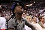 MIAMI, FL - MAY 31:  Rapper Lil Wayne looks up as he sits courtside in Game One of the 2011 NBA Finals between the Miami Heat and the Dallas Mavericks at American Airlines Arena on May 31, 2011 in Miami, Florida. NOTE TO USER: User expressly acknowledges and agrees that, by downloading and/or using this Photograph, user is consenting to the terms and conditions of the Getty Images License Agreement.  (Photo by Mike Ehrmann/Getty Images)