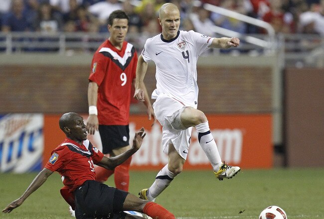 DETROIT, MI - JUNE 7: Michael Bradley #4 of the United States tries to get the ball by jumping over the leg of Atiba Hutchinson #13 of Canada during the 2011 Gold Cup  at Ford Field on June 7, 2011 in Detroit, Michigan. The United States won the game 2-0. (Photo by Gregory Shamus/Getty Images)