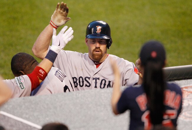 BALTIMORE, MD - MAY 22:  Kevin Youkilis #20 of the Boston Red Sox celebrates with teammates after hitting a solo home run during the fourth inning against the Baltimore Orioles at Oriole Park at Camden Yards on May 22, 2012 in Baltimore, Maryland.  (Photo by Rob Carr/Getty Images)