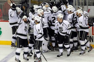 NEWARK, NJ - JUNE 02:  Jeff Carter #77 of the Los Angeles Kings celebrates with teammates after scoring the game winning goal in overtime against the New Jersey Devils during Game Two of the 2012 NHL Stanley Cup Final at the Prudential Center on June 2, 2012 in Newark, New Jersey.  (Photo by Paul Bereswill/Getty Images)