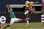 ARLINGTON, TX - JUNE 3: Defenseman Oscar #10 of Brazil attempts a shot on goal as midfielder Andres Guardado #18 defends during the first half of a soccer game at Cowboys Stadium on June 3, 2012 in Arlington, Texas. (Photo by Brandon Wade/Getty Images)