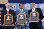 COOPERSTOWN, NY - JULY 24:   (L-R) Pat Gillick, Roberto Alomar and Bert Blyleven pose with their plaques after their induction at Clark Sports Center during the Baseball Hall of Fame induction ceremony on July 24, 2011 in Cooperstown, New York. In 17 major league seasons, Alomar tallied 2,724 hits, 210 home runs, 1,134 RBI, a .984 fielding percentage and a .300 batting average. Blyleven finished his 22 season career with 3,701 strikeouts (fifth on the all-time list) and 287 wins including 60 shutouts and 242 complete games.Gillick spent 27 years as the general manger with four major league clubs (Toronto 1978-94, Baltimore 1996-98, Seattle 2000-03 and Philadelphia 2006-08). His teams advanced to the postseason 11 times and won the World Series in 1992, 1993 and 2008.  (Photo by Jim McIsaac/Getty Images)