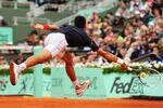 PARIS, FRANCE - JUNE 03:  Novak Djokovic of Serbia stretches for a volley in his men's singles fourth round match against Andreas Seppi of Italy during day 8 of the French Open at Roland Garros on June 3, 2012 in Paris, France.  (Photo by Mike Hewitt/Getty Images)