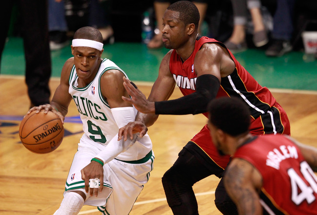 BOSTON, MA - JUNE 07:  Rajon Rondo #9 of the Boston Celtics drives Dwyane Wade #3 and Udonis Haslem #40 of the Miami Heat in Game Six of the Eastern Conference Finals in the 2012 NBA Playoffs on June 7, 2012 at TD Garden in Boston, Massachusetts. NOTE TO USER: User expressly acknowledges and agrees that, by downloading and or using this photograph, User is consenting to the terms and conditions of the Getty Images License Agreement.  (Photo by Jared Wickerham/Getty Images)