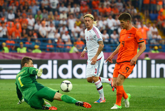 KHARKOV, UKRAINE - JUNE 09:  Klaas Jan Huntelaar of Netherlands tries to chip the ball over goalkeeper Stephan Andersen of Denmark during the UEFA EURO 2012 group B match between Netherlands and Denmark at Metalist Stadium on June 9, 2012 in Kharkov, Ukraine.  (Photo by Lars Baron/Getty Images)