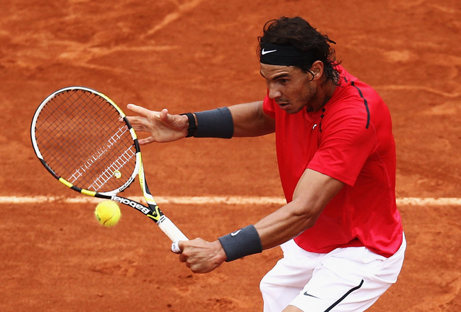PARIS, FRANCE - JUNE 10:  Rafael Nadal of Spain plays a backhand during the men's singles final against Novak Djokovic of Serbia on day 15 of the French Open at Roland Garros on June 10, 2012 in Paris, France.  (Photo by Matthew Stockman/Getty Images)