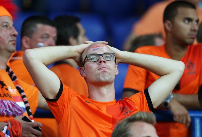 KHARKOV, UKRAINE - JUNE 09:  Dutch fans look dejected at the final whistle the UEFA EURO 2012 group B match between Netherlands and Denmark at Metalist Stadium on June 9, 2012 in Kharkov, Ukraine.  (Photo by Julian Finney/Getty Images)