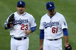LOS ANGELES, CA - SEPTEMBER 01:   Pitcher Josh Beckett #61 and first baseman Adrian Gonzalez #23 of the Los Angeles Dodgers walk to the dugout after retiring the Arizona Diamondbacks in the second inning on September 1, 2012 at Dodger Stadium in Los Angeles, California.  (Photo by Stephen Dunn/Getty Images)