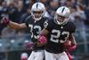 OAKLAND, CA - OCTOBER 21: Defensive back Joselio Hanson #23 of the Oakland Raiders celebrates with Tyvon Branch #33 after recoviner a fumble against the Jacksonville Jaguars during overtime at O.co Coliseum on October 21, 2012 in Oakland, California. The Oakland Raiders defeated the Jacksonville Jaguars 26-23 in overtime. Photo by Jason O. Watson/Getty Images)