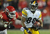 KANSAS CITY, MO - NOVEMBER 27:  Wide receiver Emmanuel Sanders #88 of the Pittsburgh Steelers rushes up field after making a catch against pressure from Justin Houston #50 of the Kansas City Chiefs during the second half on November 27, 2011 at Arrowhead Stadium in Kansas City, Missouri.  Pittsburgh defeated Kansas City 13-9.  (Photo by Peter Aiken/Getty Images)
