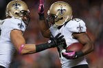 DENVER, CO - OCTOBER 28:  Running back Darren Sproles #43 and tight end Jimmy Graham #80 of the New Orleans Saints celebrate a second quarter Sproles touchdown during a game against the Denver Broncos at Sports Authority Field Field at Mile High on October 28, 2012 in Denver, Colorado. (Photo by Dustin Bradford/Getty Images)