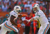 MIAMI GARDENS, FL - DECEMBER 02: Ryan Tannehill #17 of the Miami Dolphins hands off to Reggie Bush #22 during a game against the New England Patriots at Sun Life Stadium on December 2, 2012 in Miami Gardens, Florida.  (Photo by Mike Ehrmann/Getty Images)