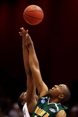 DAYTON, OH - MARCH 22: Alex Franklin #42 of the Siena Saints and Samardo Samuels #24 of the Louisville Cardinals go up for the opening tip-off during the second round of the NCAA Division I Men's Basketball Tournament at the University of Dayton Arena on 