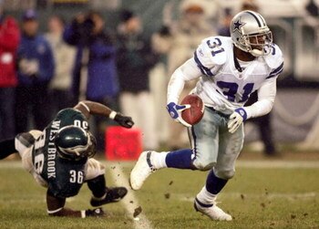 PHILADELPHIA - DECEMBER 19:  Safety Roy Williams #31 of the Dallas Cowboys avoids a tackle by running back Brian Westbrook #36 of the Philadelpia Eagles after Williams intercepted a pass at Lincoln Financial Field on December 19, 2004 in Philadelphia, Pen