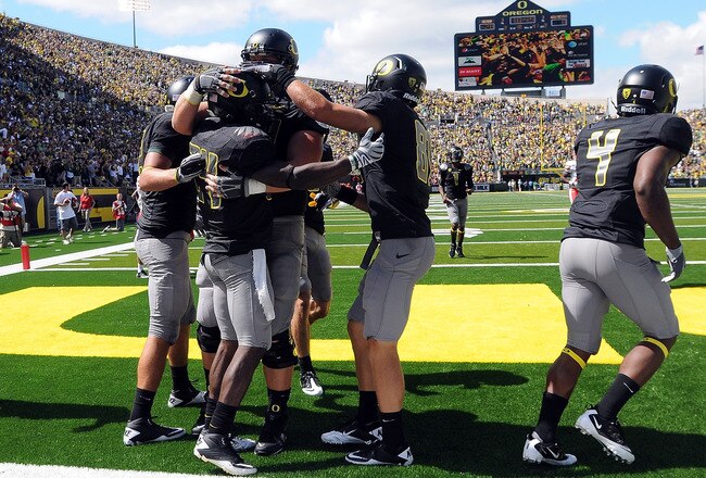 EUGENE, OR - SEPTEMBER 04: Running back Kenjon Barner #24 of the Oregon Ducks is mobbed in the endzone by his teammates after scoring a touchdown in the second quarter of the game against the New Mexico Lobos at Autzen Stadium on September 4, 2010 in Euge