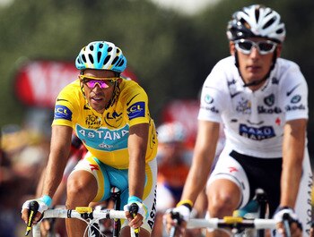 PAU, FRANCE - JULY 20:  Race leader Alberto Contador (l) of Spain and the Astana team rides over the finish line alongside second placed Andy Schleck of Luxembourg and Team Saxo Bank on stage sixteen of the 2010 Tour de France from Bagneres-de-Luchon to P