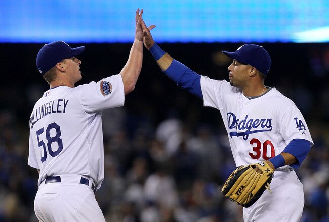 LOS ANGELES, CA - JULY 21:  Pitcher Chad Billingsley #58 of the Los Angeles Dodgers is congratulated by outfielder Xavier Paul #30 after his complete game shutout against the San Francisco Giants on July 21, 2010 at Dodger Stadium in Los Angeles, Californ