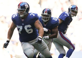 IRVING, TX - OCTOBER 16: Quarterback Eli Manning #10 of the New York Giants looks back after handing the ball off to Tiki Barber #21 with a lead block from Chris Snee #76 against the Dallas Cowboys on October 16, 2005 at Texas Stadium in Irving, Texas. (P