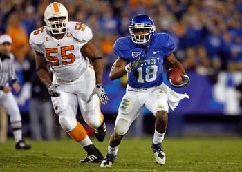 LEXINGTON, KY - NOVEMBER 28:  Randall Cobb #18 of the Kentucky Wildcats runs with the ball while defended by Dan Williams #55 of the Tennessee Volunteers during the SEC game at Commonwealth Stadium on November 28, 2009 in Lexington, Kentucky.  (Photo by A