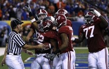 ATLANTA - DECEMBER 5:  Mark Ingram #22 of the Alabama Crimson Tidecelebrates with teammates after he scored a 3-yard rushing touchdown in the second quarter against the Florida Gators during the SEC Championship game at Georgia Dome on December 5, 2009 in