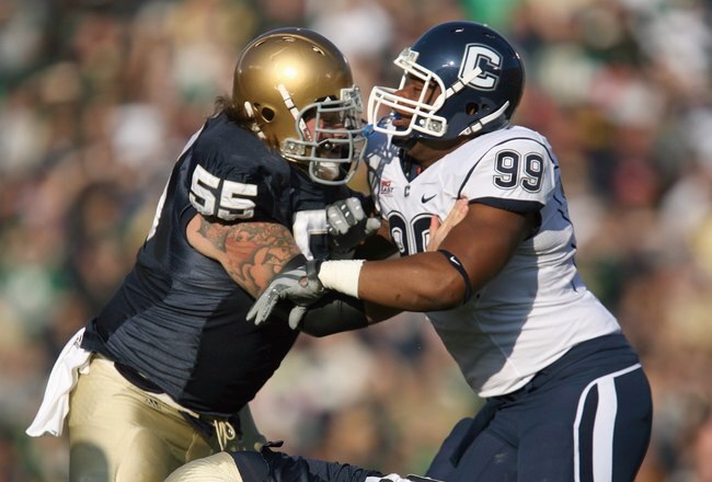 SOUTH BEND, IN - NOVEMBER 21: Guard Eric Olsen #55  of the Notre Dame Fighting Irish blocks Kendall Reyes #99 of the Univeristy of Connecticut Huskies at Notre Dame Stadium on November 21, 2009 in South Bend, Indiana. (Photo by Jonathan Daniel/Getty Image
