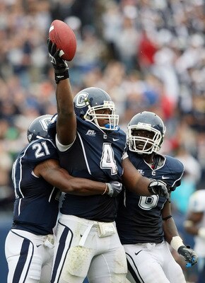 EAST HARTFORD, CT - SEPTEMBER 12:  Twyon Martin #4 of the Connecticut Huskies celebrates his fumble recovery with teammates Gary Wilburn #21 and Jasper Howard #6 in the second half against the North Carolinia Tar Heels on September 12, 2009 at Rentschler 