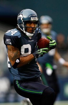 SEATTLE , WA - JANUARY 03:  T.J. Houshmandzadeh #84 of the Seattle Seahawks runs after a catch against the Tennessee Titans at Qwest Field on January 3, 2010 in Seattle, Washington.  (Photo by Jonathan Ferrey/Getty Images)