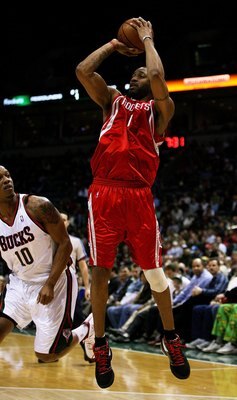 MILWAUKEE - FEBRUARY 09: Tracy McGrady #1 of the Houston Rockets puts up a shot over Keith Bogans #10 of the Milwaukee Bucks on February 9, 2009 at the Bradley Center in Milwaukee, Wisconsin. The Bucks defeated the Rockets 124-112. NOTE TO USER: User expr