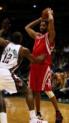 MILWAUKEE - FEBRUARY 09: Tracy McGrady #1 of the Houston Rockets looks to pass over Luc Richard Mbah a Moute #12 of the Milwaukee Bucks on February 9, 2009 at the Bradley Center in Milwaukee, Wisconsin. The Bucks defeated the Rockets 124-112. NOTE TO USER