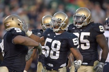 SOUTH BEND, IN - NOVEMBER 21: Brian Smith #58 of the Notre Dame Fighting Irish celebrates with teammates during the game against the Univeristy of Connecticut Huskies at Notre Dame Stadium on November 21, 2009 in South Bend, Indiana. Connecticut defeated 