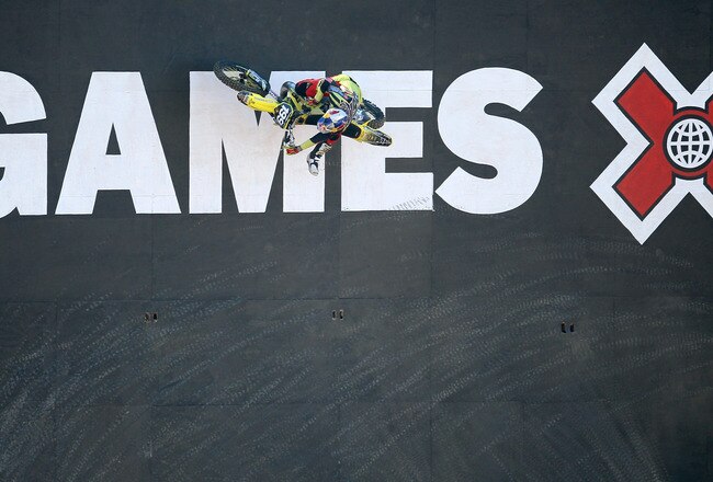 LOS ANGELES, CA - JULY 29:  Travis Pastrana #199 climbs up a wall during the Moto X Freestyle Round One at the Los Angeles Coliseum during X Games 16 on July 29, 2010 in Los Angeles, California.  (Photo by Stephen Dunn/Getty Images)