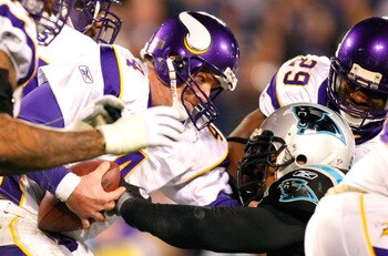 CHARLOTTE, NC - DECEMBER 20:  Quarterback Brett Favre #4 of the Minnesota Vikings escapes a sack by Julius Peppers #90 of the Carolina Panthers at Bank of America Stadium on December 20, 2009 in Charlotte, North Carolina.  (Photo by Kevin C. Cox/Getty Ima
