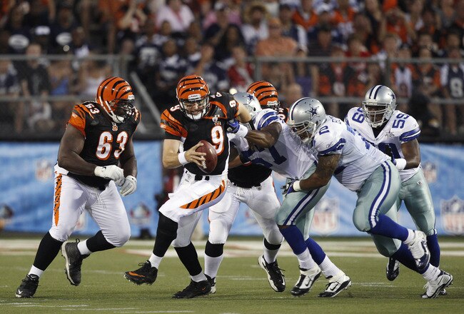 CANTON, OH - AUGUST 8: Victor Butler #57 and Stephen Brown #72 of the Dallas Cowboys sack Carson Palmer #9 of the Cincinnati Bengals during the 2010 Pro Football Hall of Fame Game at the Pro Football Hall of Fame Field at Fawcett Stadium on August 8, 2010