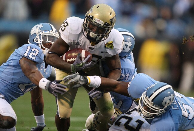 CHARLOTTE, NC - DECEMBER 26:  Dion Lewis #28 of the Pittsburgh Panthers runs with the ball against Charles Brown #12 of the North Carolina Tar Heels during their game on December 26, 2009 in Charlotte, North Carolina.  (Photo by Streeter Lecka/Getty Image