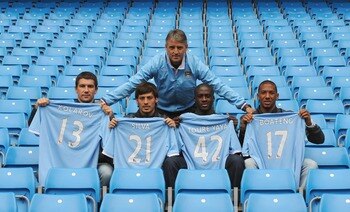 MANCHESTER, ENGLAND - AUGUST 6:  Manager Roberto Mancini (C) poses with new signings (L-R) Aleksandar Kolarov, David Silva, Yaya Toure and Jerome Boateng during a Manchester City training session at the City of Manchester Stadium on August 6, 2010 in Manc