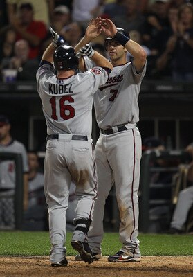 CHICAGO - AUGUST 10: Jason Kubel #16 of the Minnesota Twins is greeted at the plate by teammate Joe Mauer #7 after hitting a two-run home run in the 8th inning against the Chicago White Sox at U.S. Cellular Field on August 10, 2010 in Chicago, Illinois. T