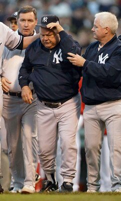 BOSTON - OCTOBER 11:  Bench coach Don Zimmer of the New York Yankees walks off the field after being thrown on the ground by Pedro Martinez #45 of the Boston Red Sox after he thought a pitch was thrown at him during Game 3 of the 2003 American League Cham