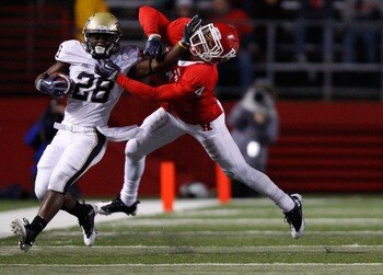 PISCATAWAY, NJ - OCTOBER 16: Dion Lewis #28 of the University of Pittsburgh Panthers stiff arms David Rowe #4 of the Rutgers University Scarlett Knights on October 16, 2009 at Rutgers Stadium in Piscataway, New Jersey. (Photo by Jared Wickerham/Getty Imag
