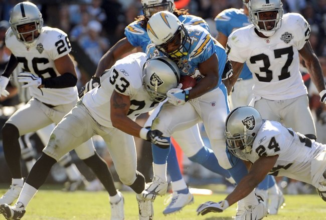 SAN DIEGO - NOVEMBER 01:  Darren Sproles #43 of the San Diego Chargers gets hit by Tyvon Branch #33 and Michael Huff #24 of the Oakland Raiders during the game at Qualcomm Stadium on November 1, 2009 in San Diego California. The Chargers defeated the Raid