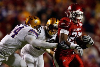 BATON ROUGE, LA - NOVEMBER 28:  Ronnie Wingo Jr. #20 of the Arkansas Razorbacks avoids a tackle by Harry Coleman #24 and Rahim Alem #84 of the LSU Tigers at Tiger Stadium on November 28, 2009 in Baton Rouge, Louisiana.  The Tigers defeated the Razorbacks