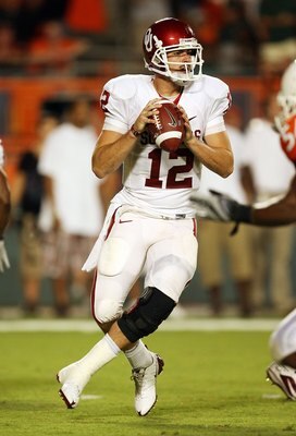 MIAMI GARDENS, FL - OCTOBER 03:  Quarterback Landry Jones #12 of the Oklahoma Sooners drops back to pass against the Miami Hurricanes at Land Shark Stadium on October 3, 2009 in Miami Gardens, Florida. Miami defeated Oklahoma 21-20.  (Photo by Doug Benc/G